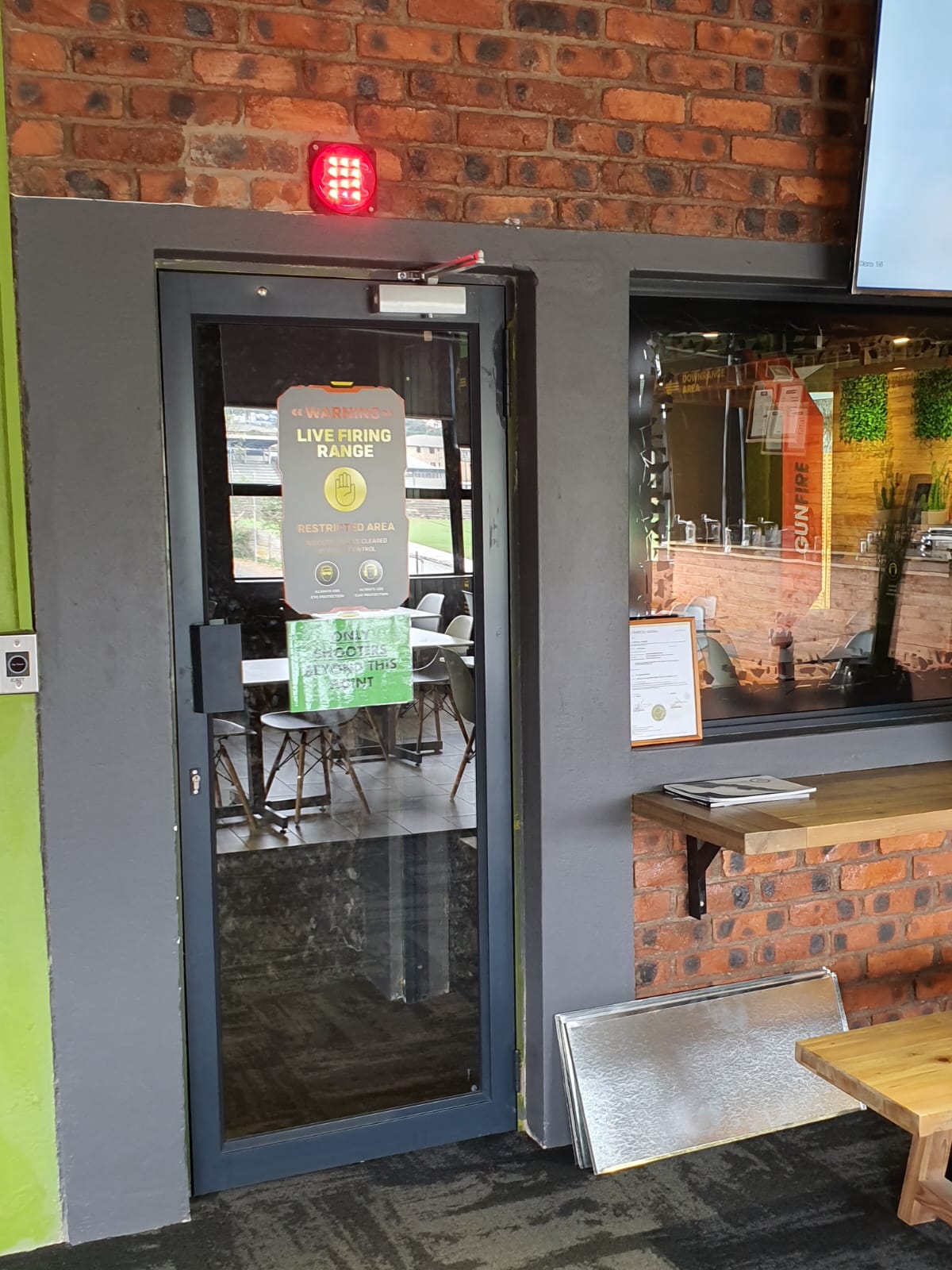 Live Firing Range access door with warning signage and red indicator light