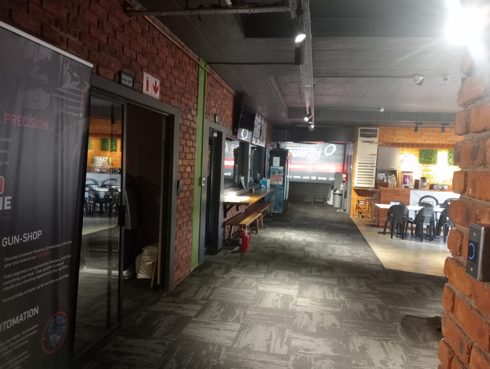 Shop corridor with timber viewing counter and the range entry door
