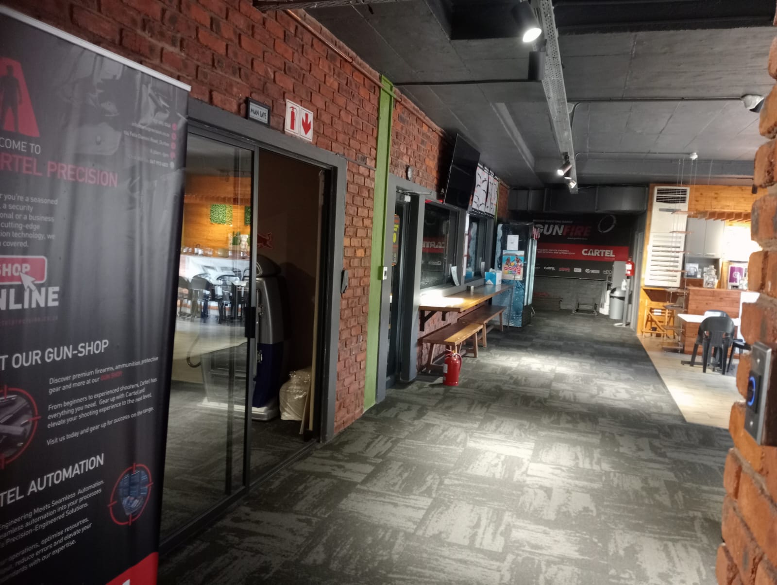 Banner-lined corridor from the shop towards the GUNFIRE range