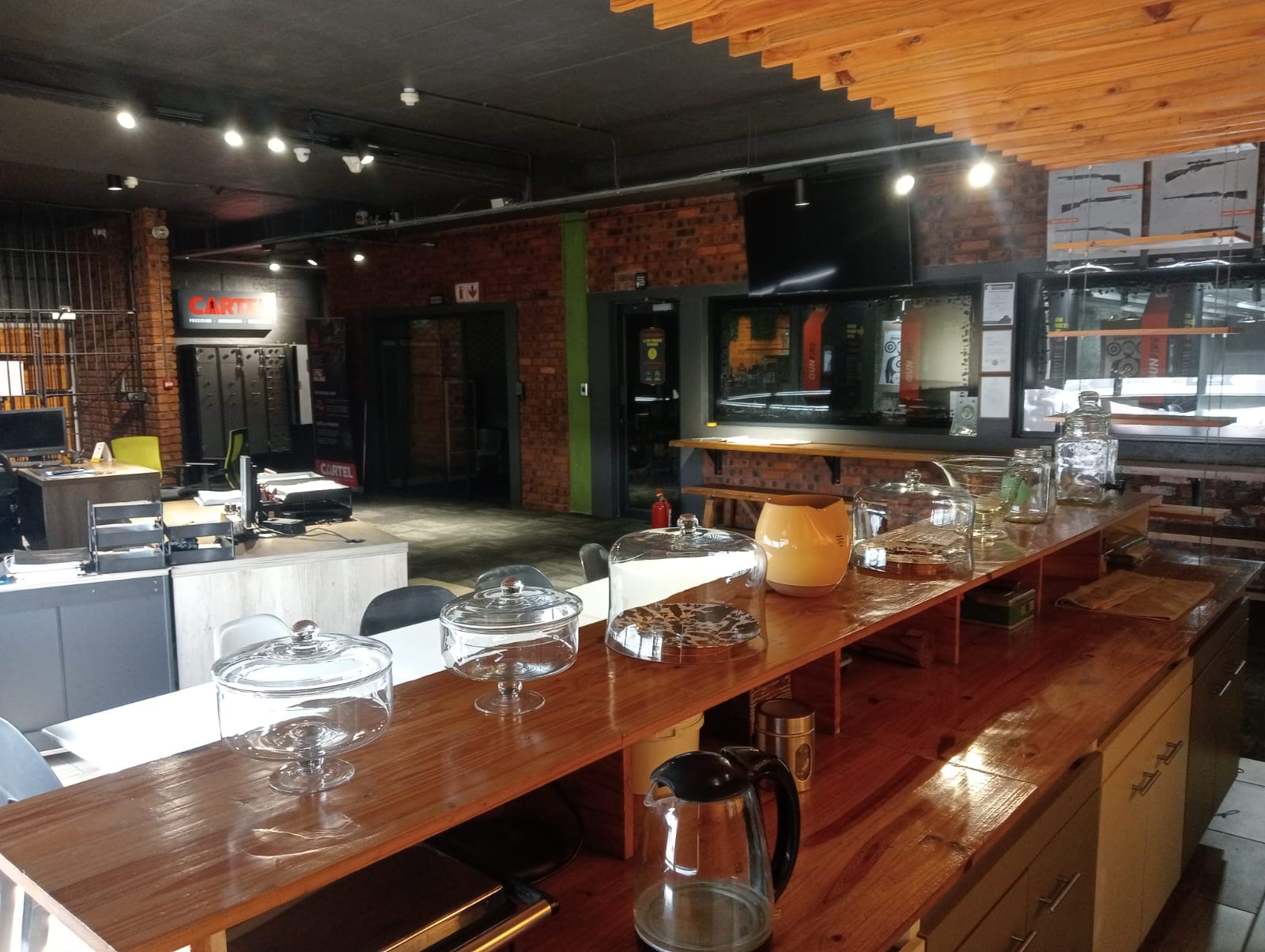 Wide view of the CARTEL coffee bar, display counter and lounge seating