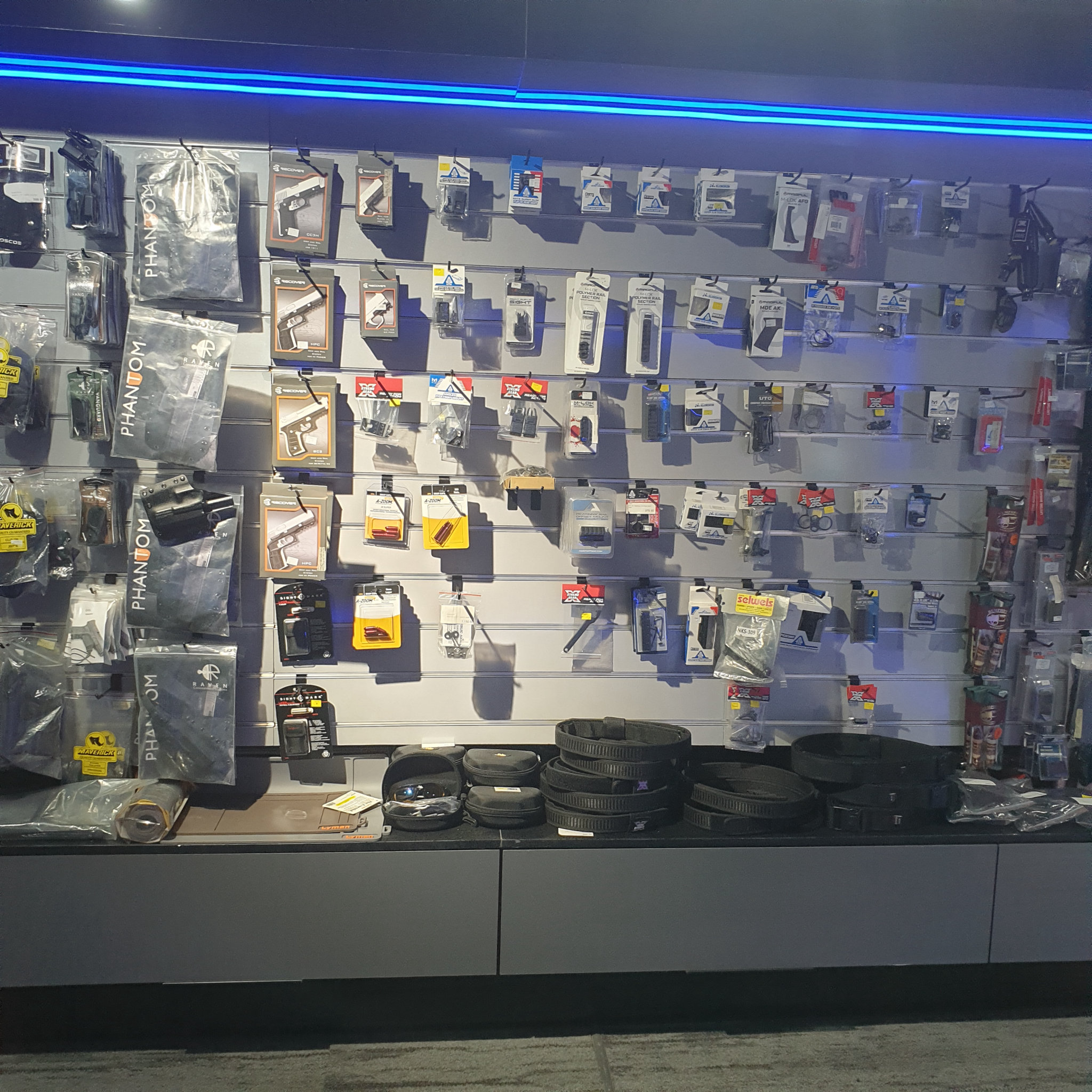 Accessories wall stocked with holsters, belts and packaged firearm parts in the gun shop